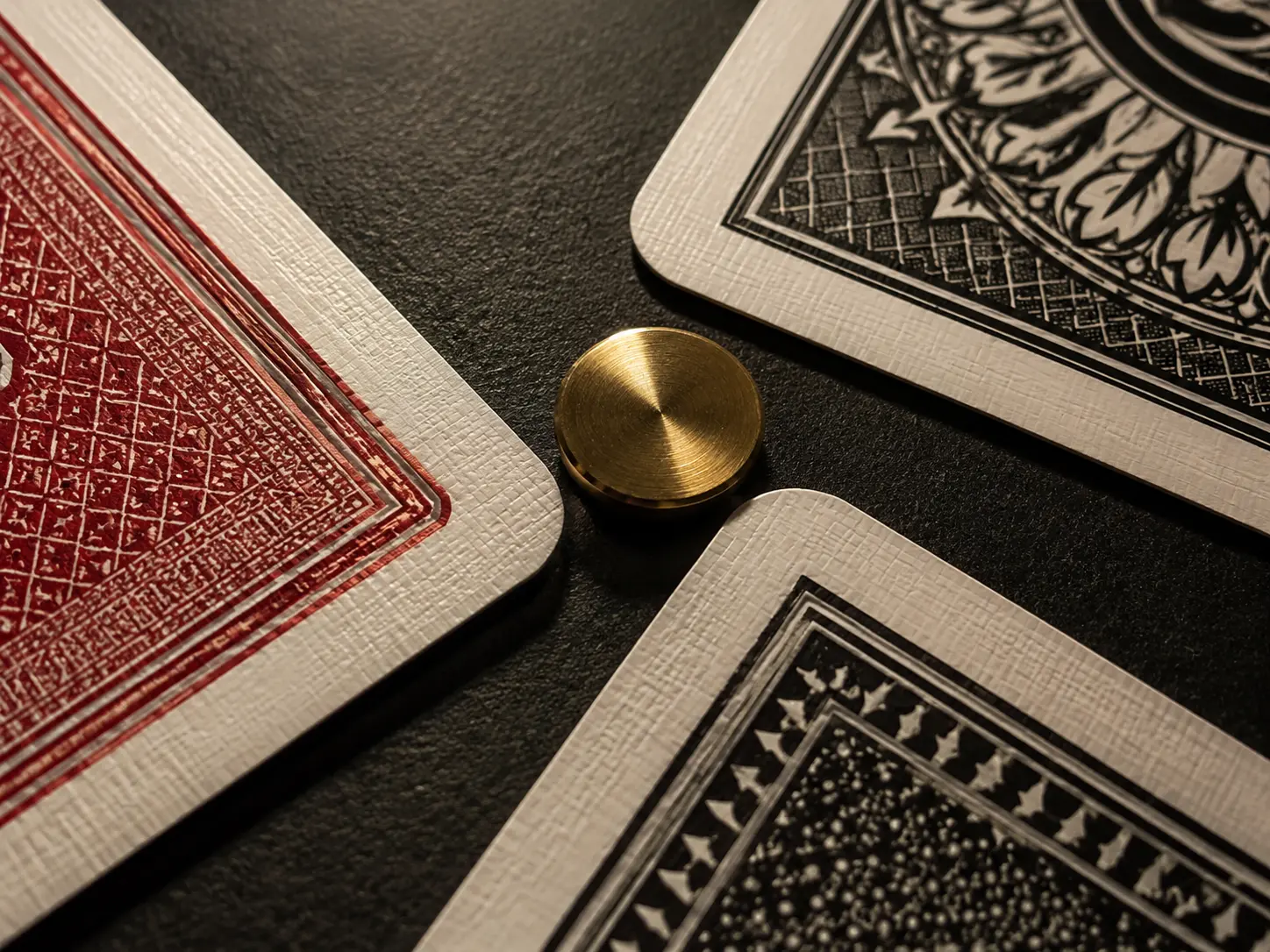 Three patterned card corners surrounding a round brass marker